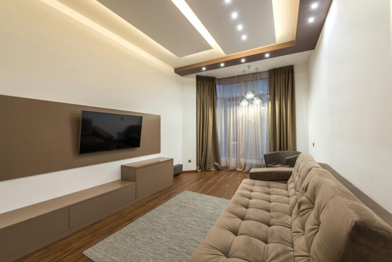 Spacious living room featuring modern design with cozy furniture and warm lighting.